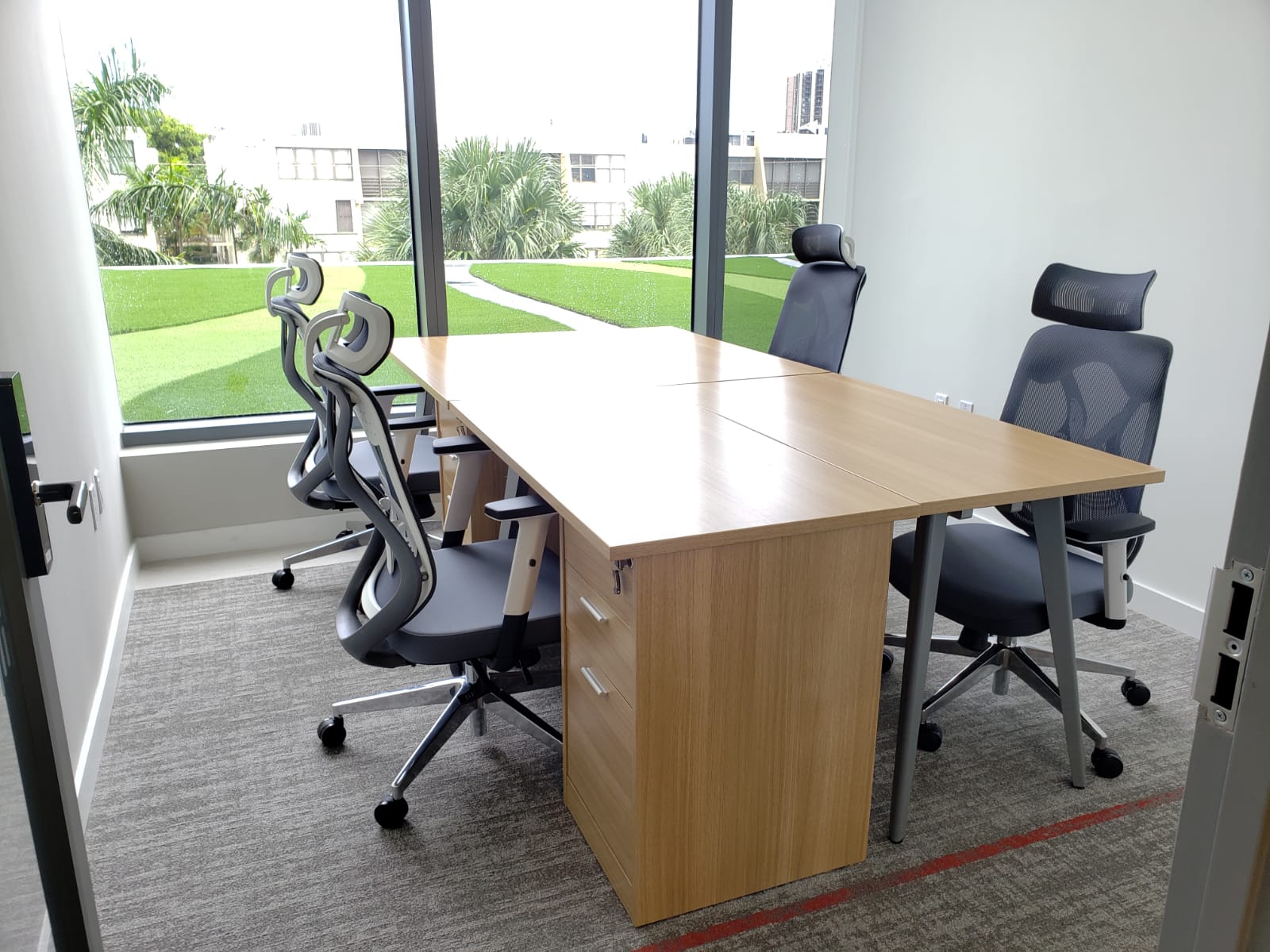 Exterior team office with a large table and ergonomic chairs