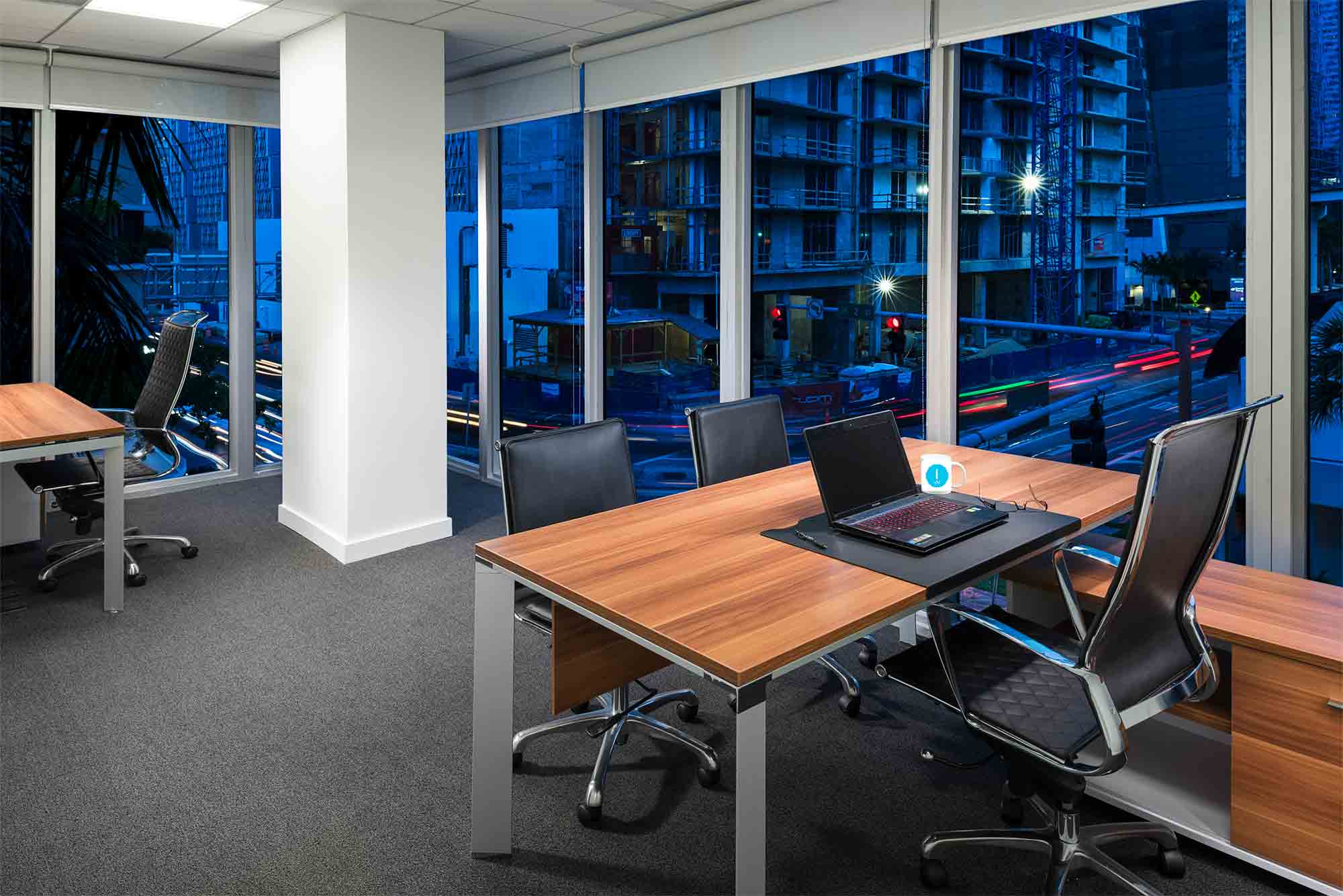 Premium private office with city skyline view at dusk