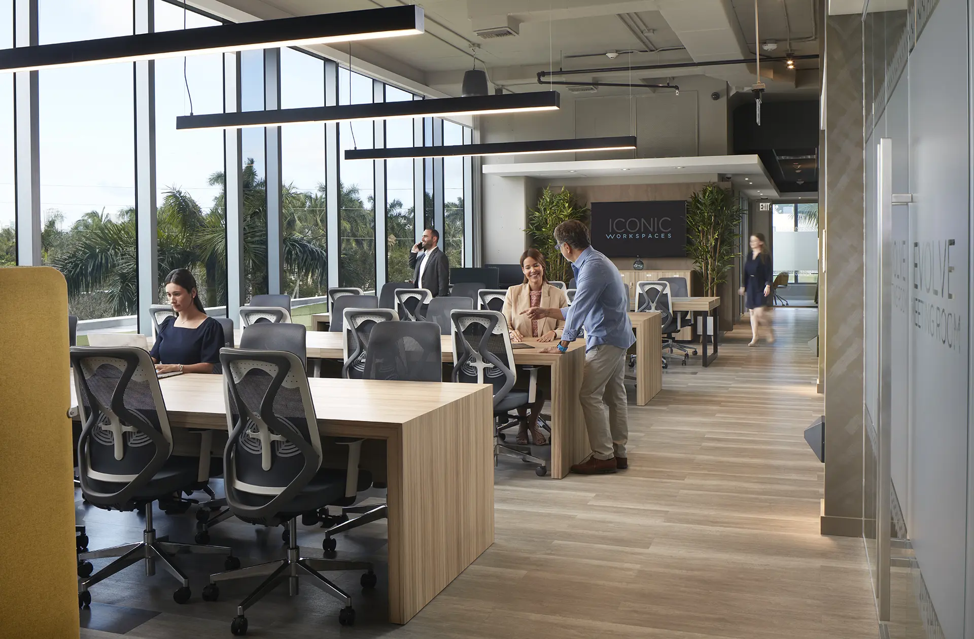 Open coworking area with shared desks and members working