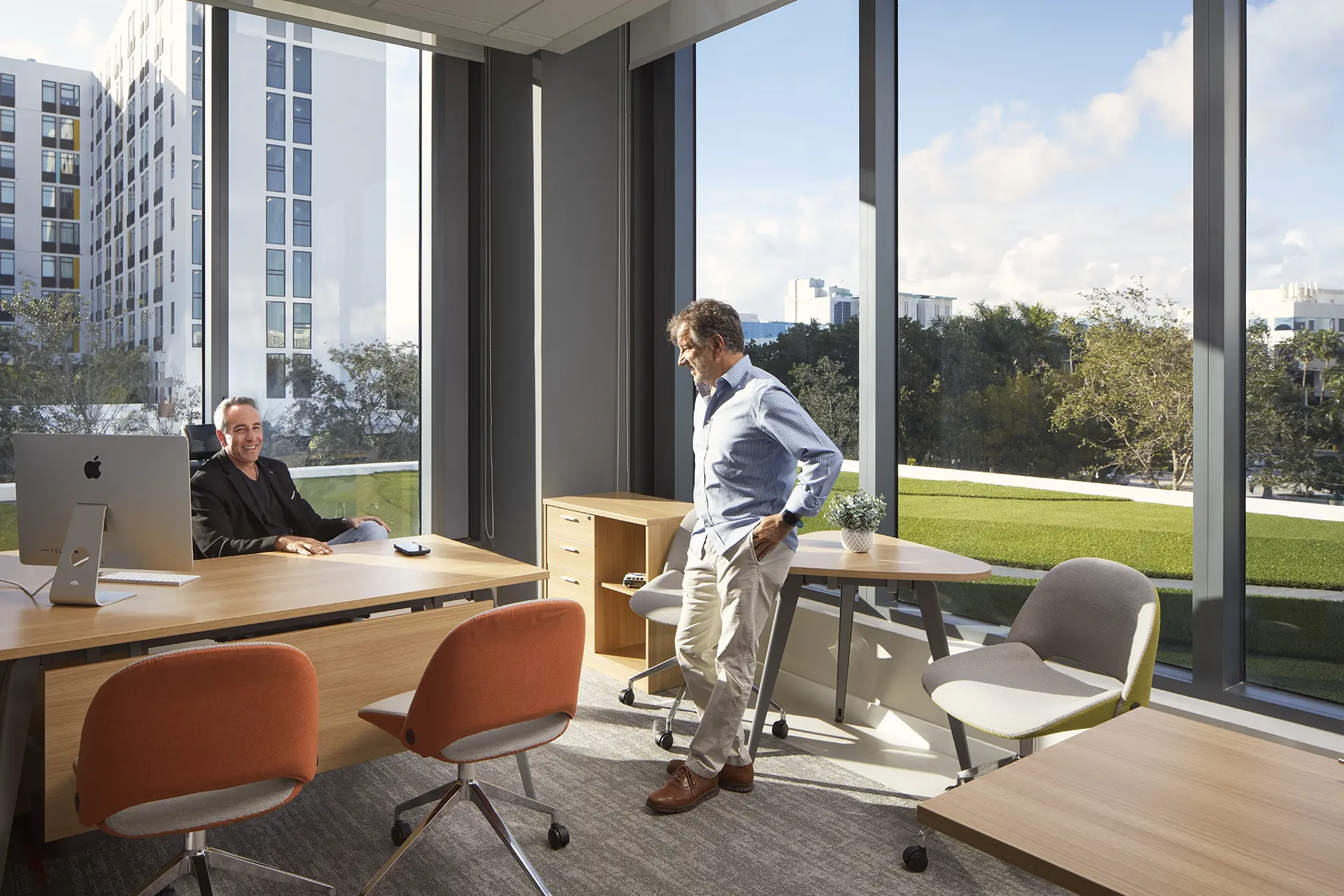 Premium private office with floor-to-ceiling windows and park view