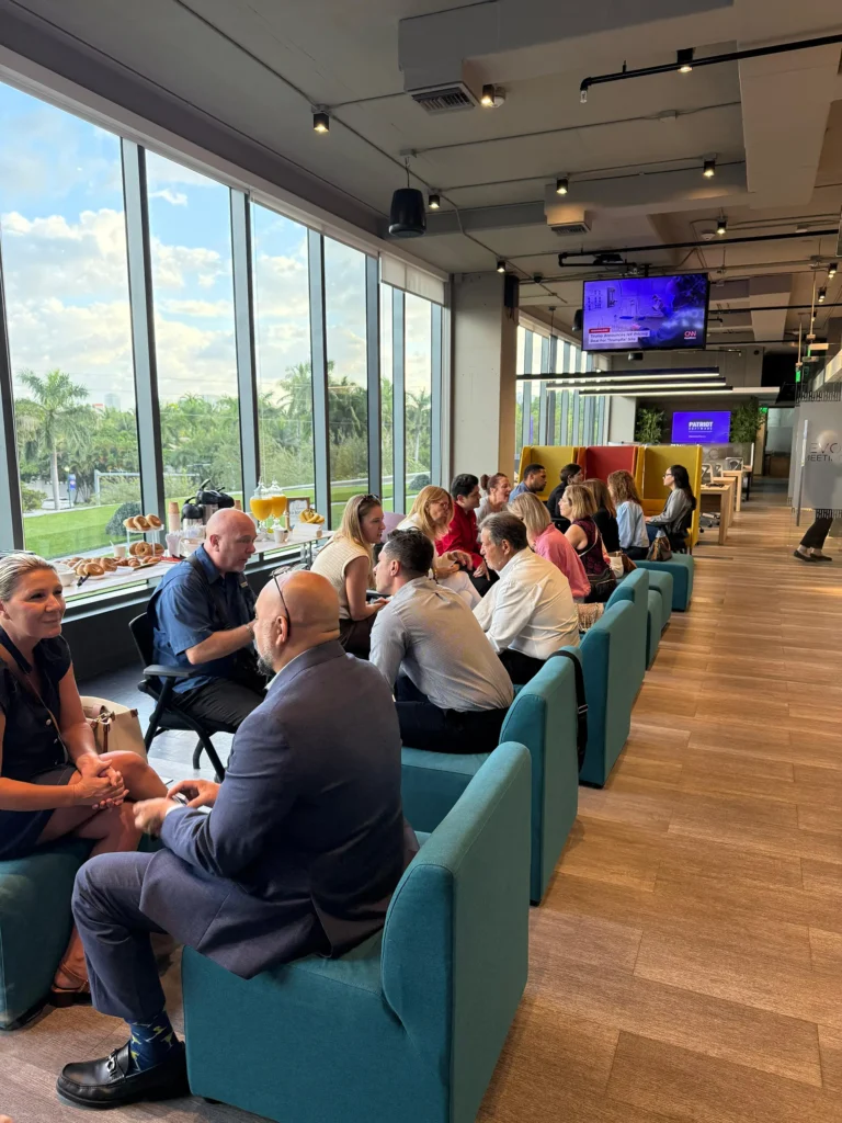 Attendees networking at an Iconic Workspaces event with food and drinks