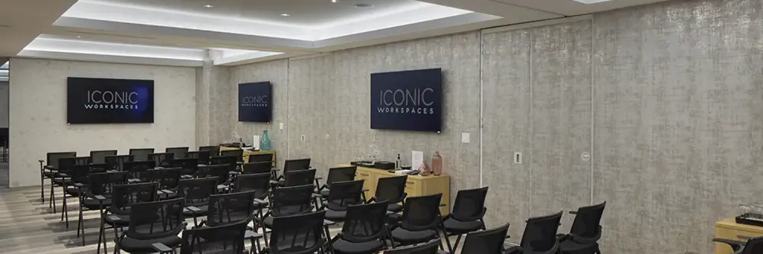 Event space with theater-style seating and Iconic Workspaces signage
