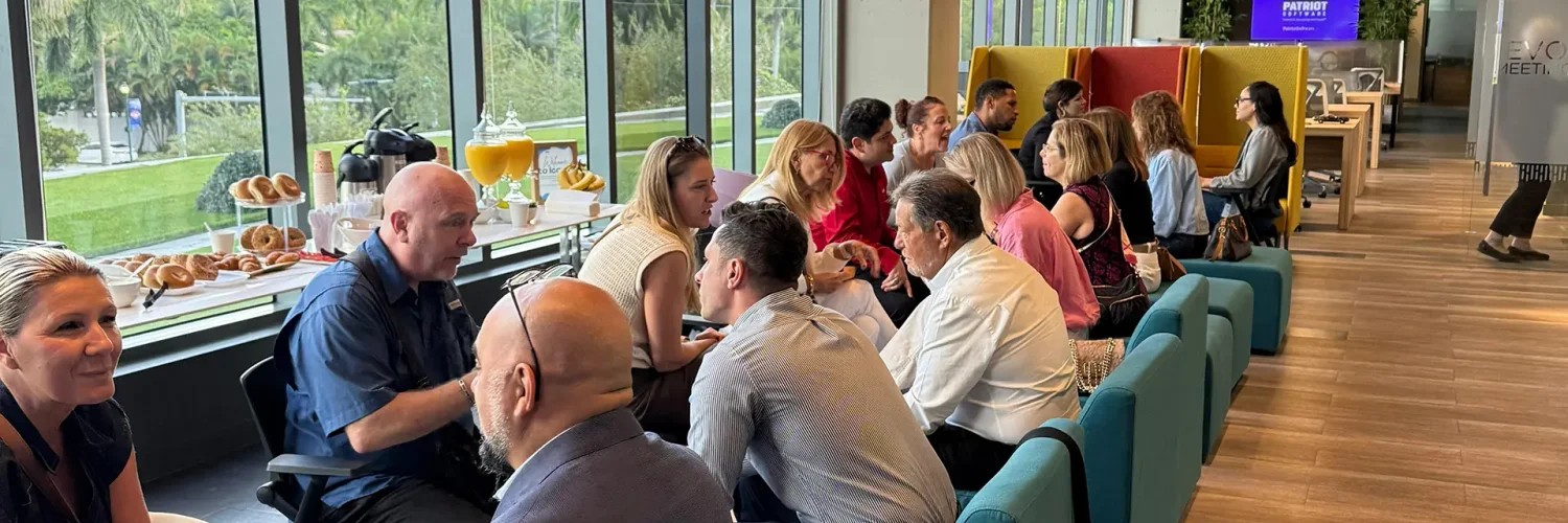 Attendees networking at an Iconic Workspaces event with food and drinks
